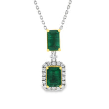 This beautiful 18k white/yellow gold pendant features 2 emeralds an...