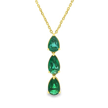 This beautiful 18k yellow gold pendant features 3 emeralds and 4 ro...