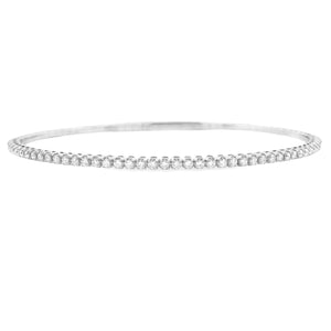 This easy to stack and style 14k gold bangle features round brillia...