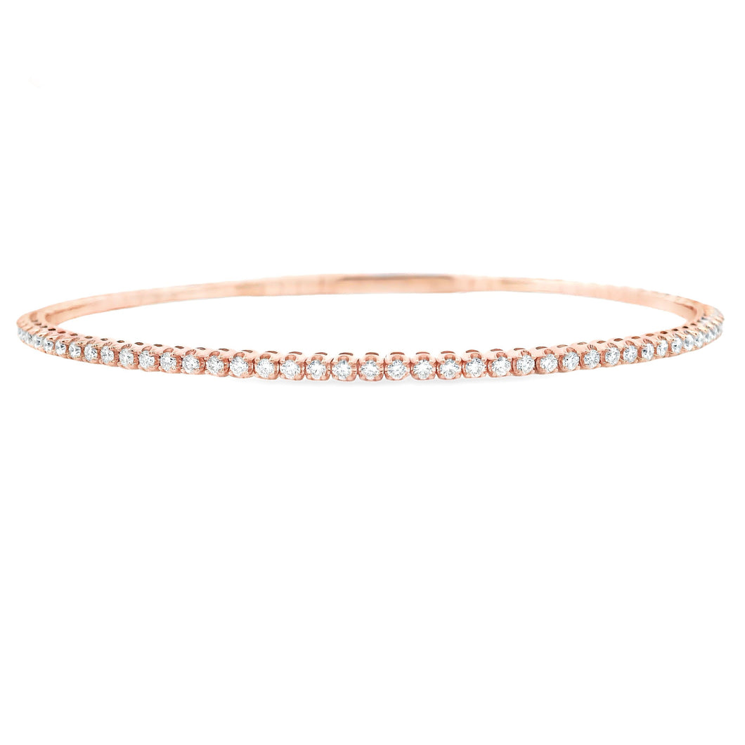 This easy to stack and style 14k gold bangle features round brillia...