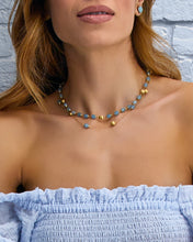 This 18-karat gold necklace blends with Laura's love for milky aqua...