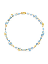 This 18-karat gold necklace blends with Laura's love for milky aqua...