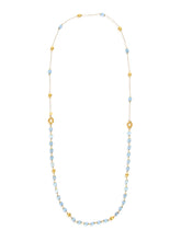 This 18-karat gold necklace blends with Laura's love for milky aqua...