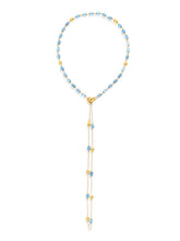 This 18-karat gold necklace blends with Laura's love for milky aqua...