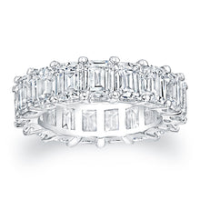 Emerald cut diamonds are set in a continuous circle using shared pr...