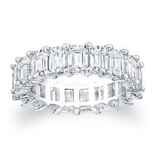Emerald cut diamonds are set in a continuous circle using shared pr...