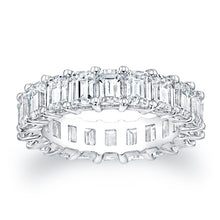 Emerald cut diamonds are set in a continuous circle using shared pr...