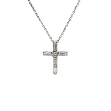 This 18k white gold diamond cross pendant features 5 baguette and 1...