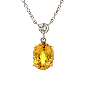 This gorgeous 14k white gold pendant features a yellow sapphire tha...