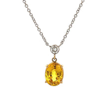 This gorgeous 14k white gold pendant features a yellow sapphire tha...