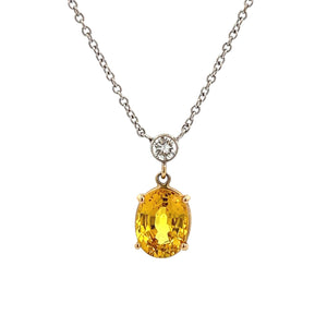 This gorgeous 14k white gold pendant features a yellow sapphire tha...