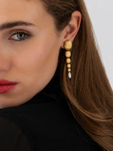 Elegant 18kt gold boules, hand-engraved with artisanal wisdom, chas...