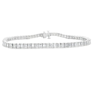 This gorgeous 18k white gold bracelet features 70 emerald cut diamo...