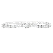 This stunning platinum bracelet features alternating emerald cut an...