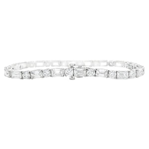 This stunning platinum bracelet features alternating emerald cut an...