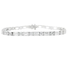 This stunning platinum bracelet features alternating emerald cut an...