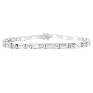 This stunning platinum bracelet features alternating emerald cut an...
