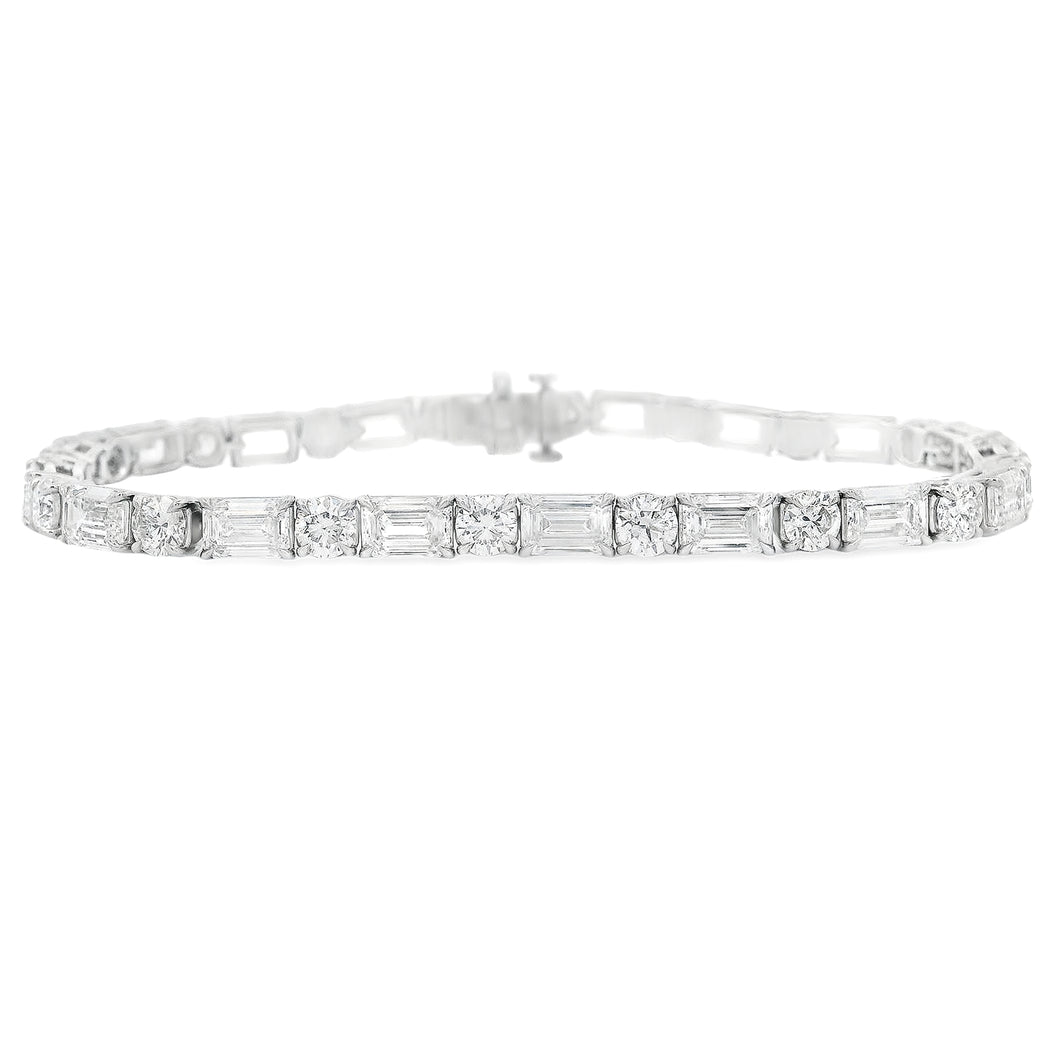 This stunning platinum bracelet features alternating emerald cut an...