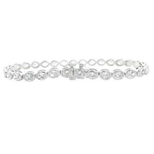 This beautiful 18k white gold bracelet features 32 oval cut diamond...