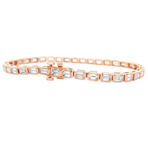 This beautiful 18k rose gold bracelet features 36 emerald cut diamo...