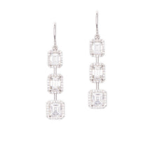 These elegant 18k white gold dangle earrings feature 6 emerald cut ...