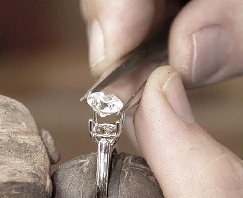 Precision Set jeweler setting a diamond by hand