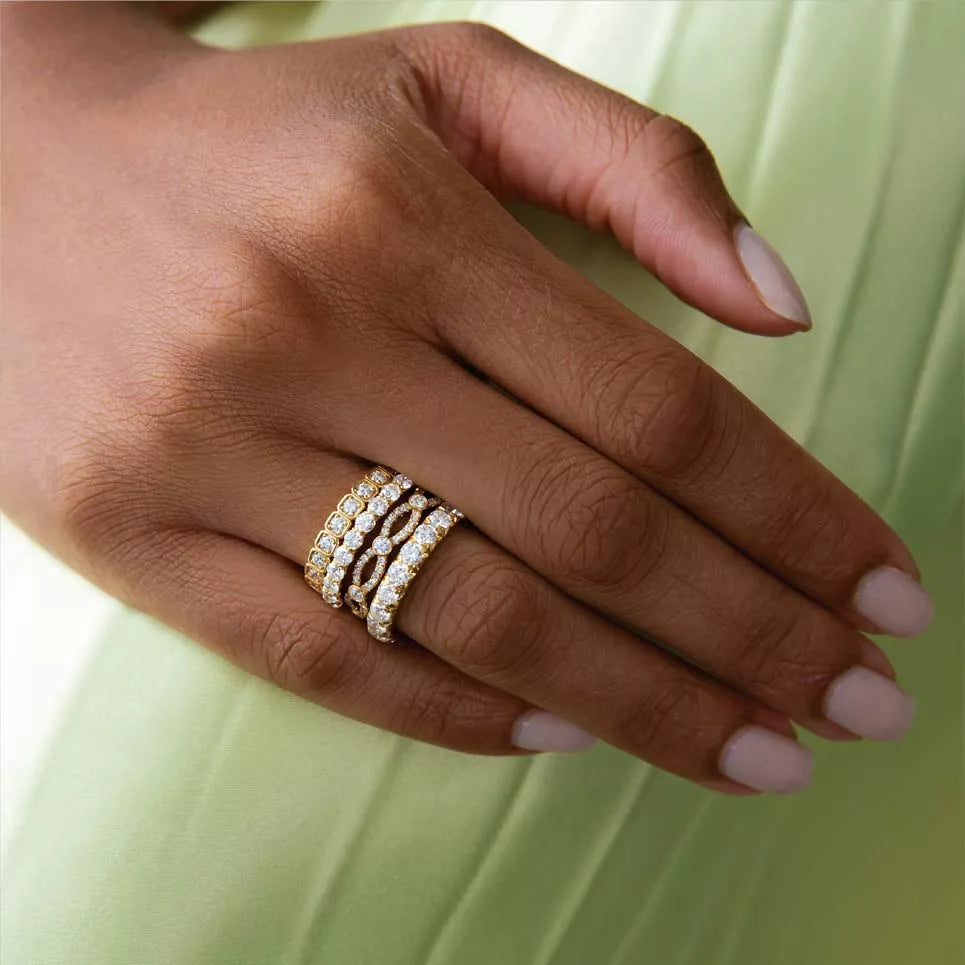 Stacked Precision Set diamond rings on a hand