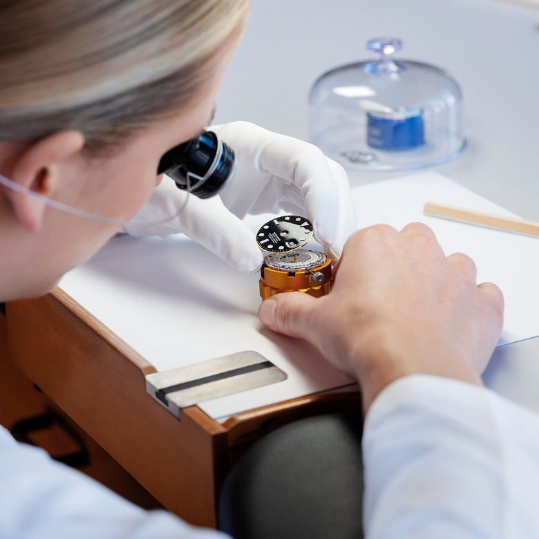 Rolex watchmaker assembling a movement