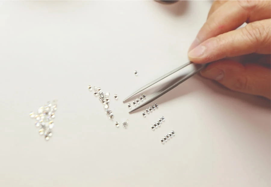 Loose diamonds being hand-selected with tweezers at the Verragio atelier