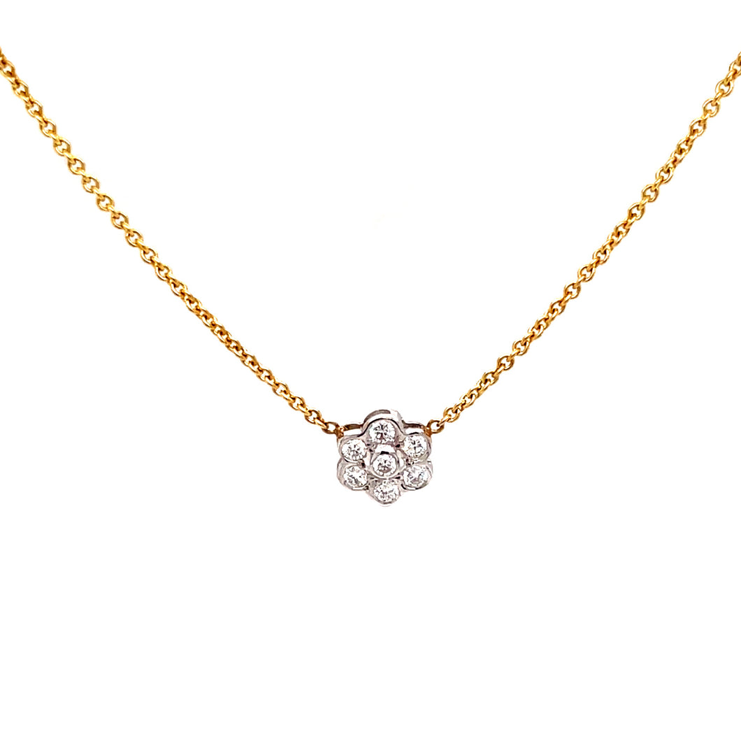 features a small flower pendant with round brilliant cut diamonds t...