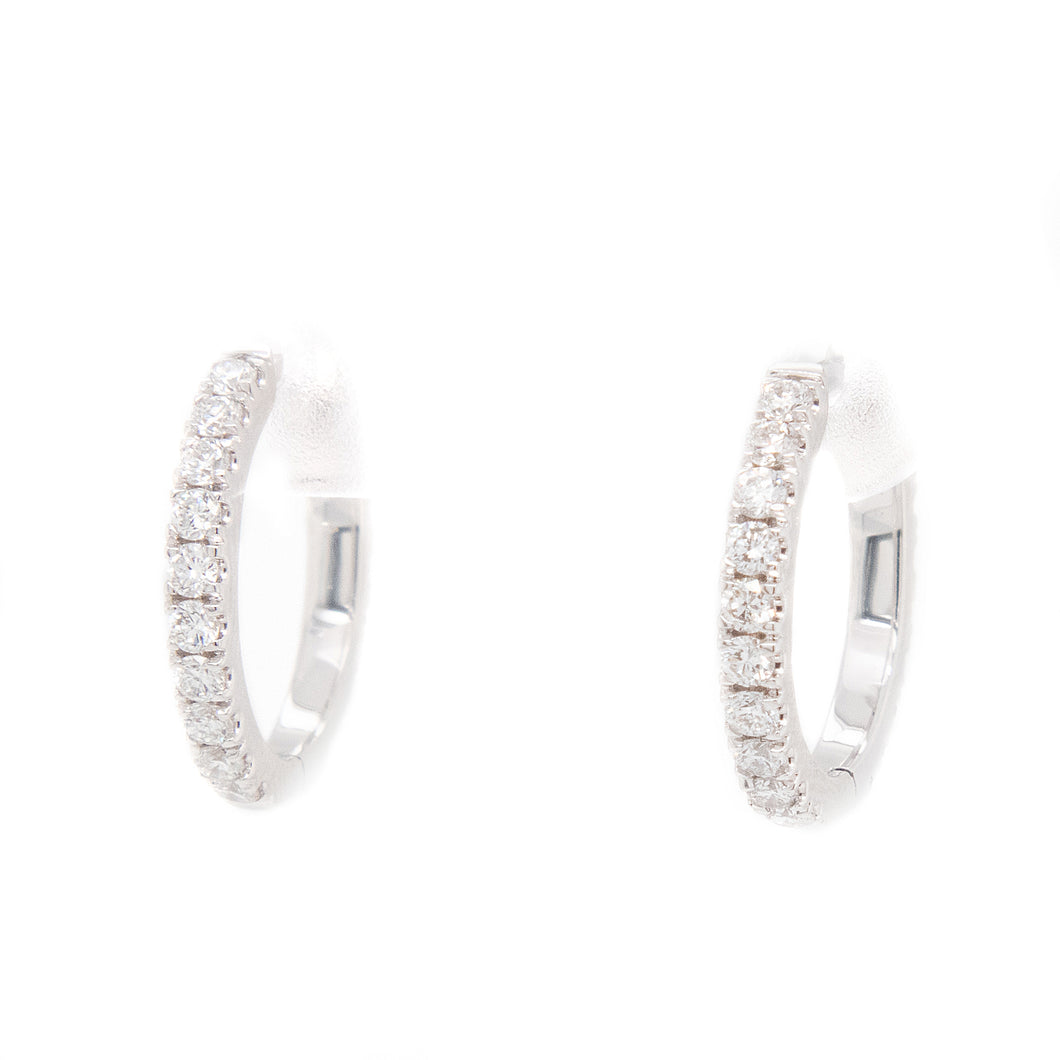 These huggy hoops feature round brilliant cut diamonds totaling 0.6...