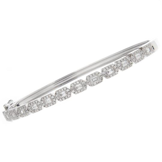 This classic 14k white gold bangle features baguette and round bril...