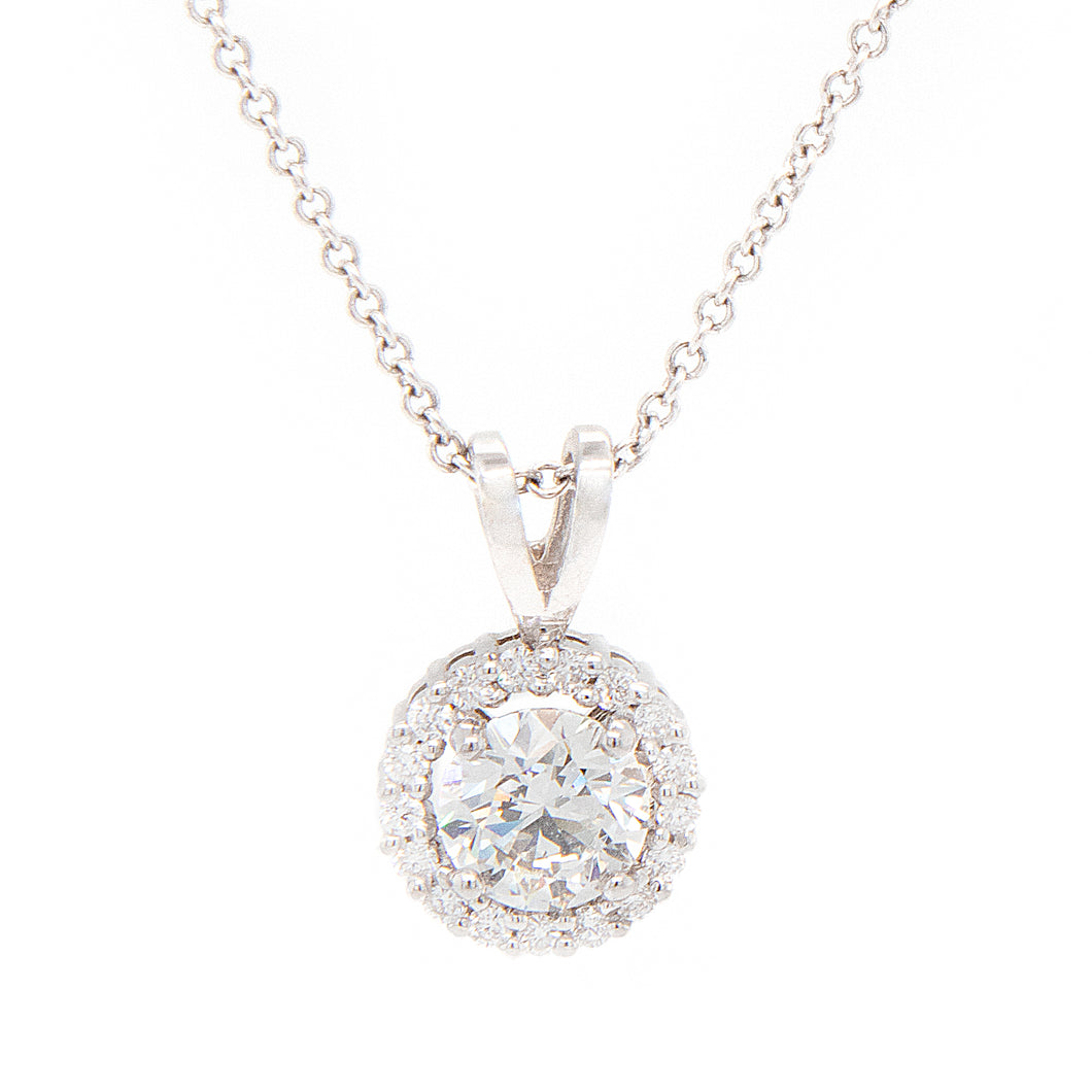 This pendant features a center round brilliant cut diamond totaling...