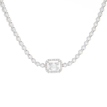 This elegant 18k white gold necklace features baguette and round br...