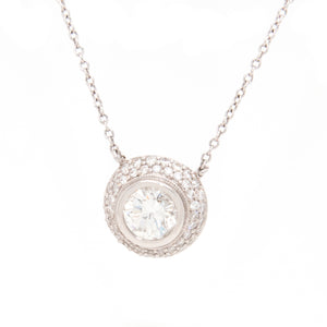 The stunning round brilliant cut center diamond in this pendant tot...