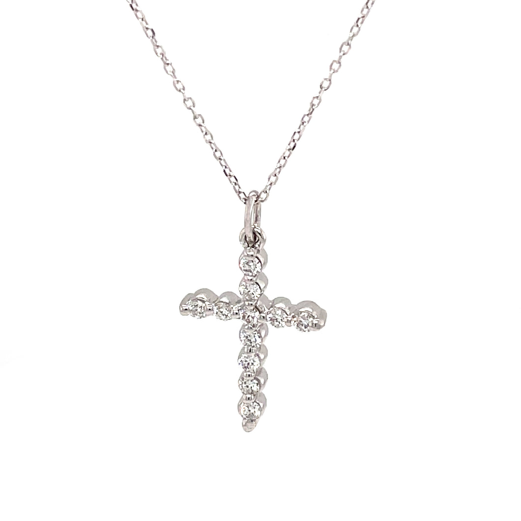 This cross pendant features 11 round brilliant cut diamonds totalin...