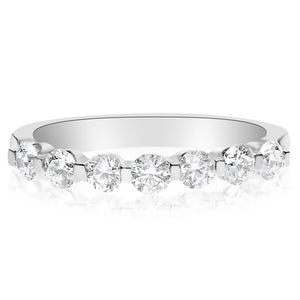This diamond band features round brilliant cut diamonds that total ...