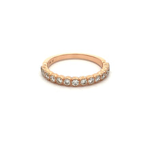 This stackable 14k rose gold diamond band features 14 bezel set dia...