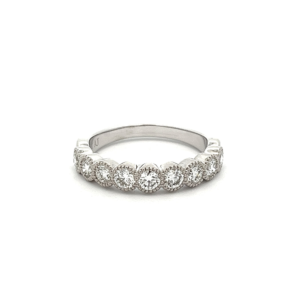 This stackable diamond band features 9 bezel set diamonds totaling ...