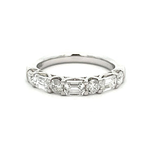 This gorgeous ring features round brilliant cut diamonds and emeral...