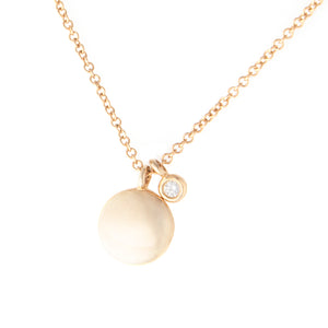 This yellow gold necklace features a small disk pendant with a mini...