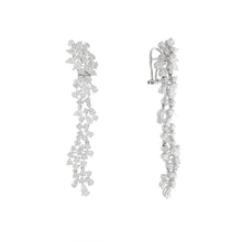 These diamond earrings feature round and pear diamonds that total 8...