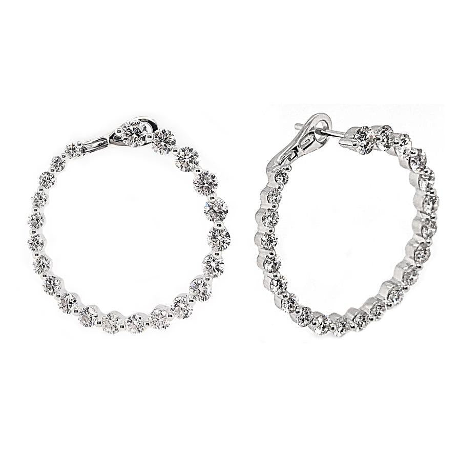 These earrings feature prong set round brilliant cut diamonds that ...