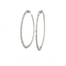 These classic hoops feature 90 round brilliant cut diamonds totalin...