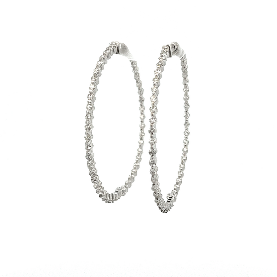 These classic hoops feature 90 round brilliant cut diamonds totalin...