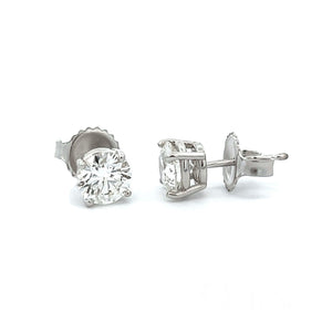 A vibrant perfectly matched pair of round brilliant cut diamonds to...