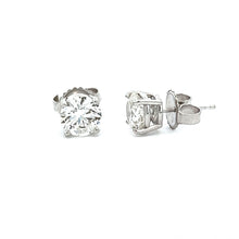 A vibrant perfectly matched pair of round brilliant cut diamonds to...