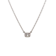 A .30ct emerald cut diamond is bezel-set in this solitaire pendant....