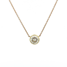 This classic bezel-set pendant is made in 14k yellow and white gold...