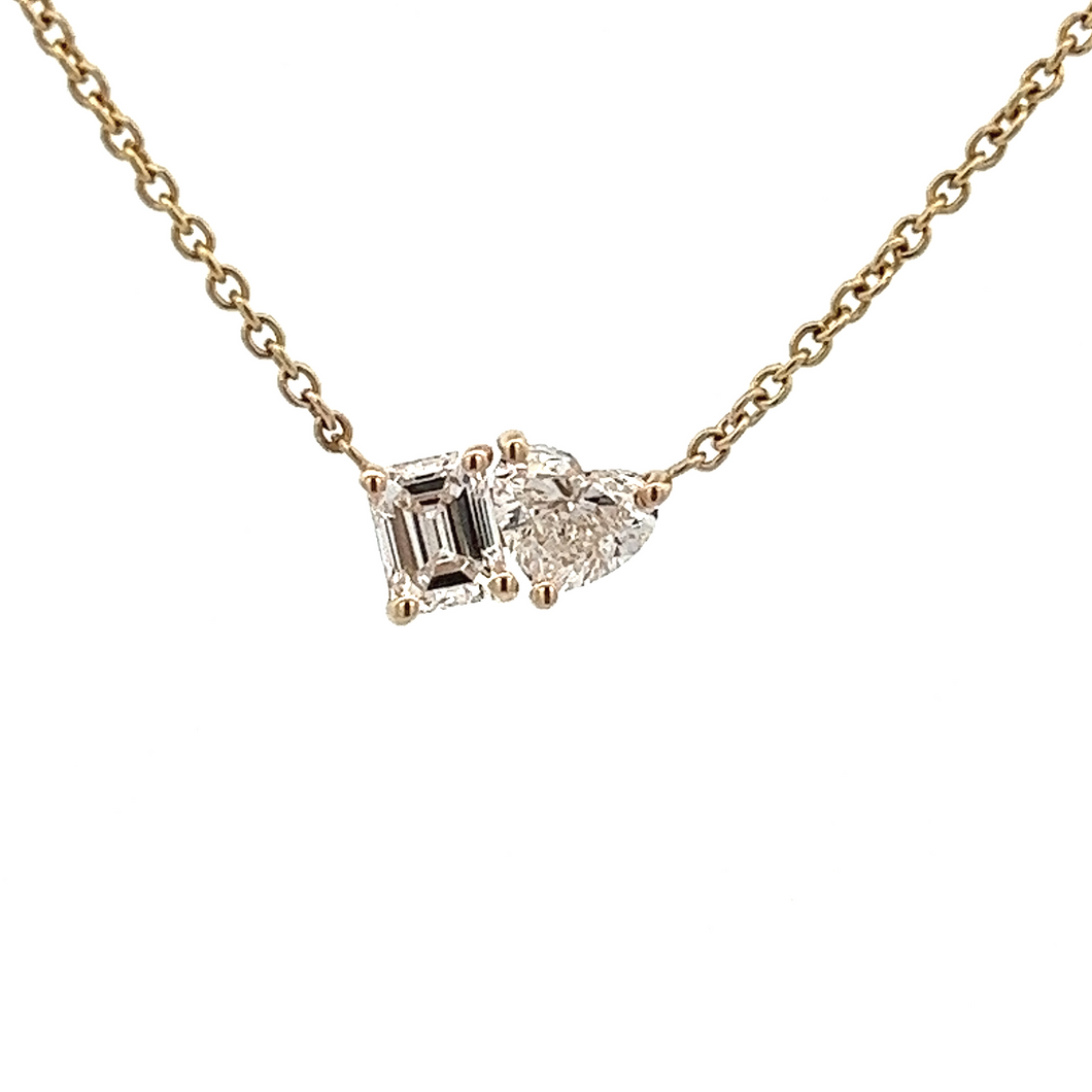 This necklace features 2 diamonds, a heart shape diamond and an eme...